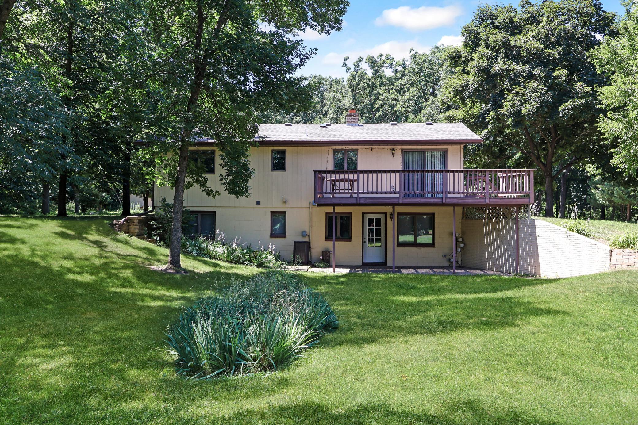 Back of home with a deck and walkout to patio.jpg