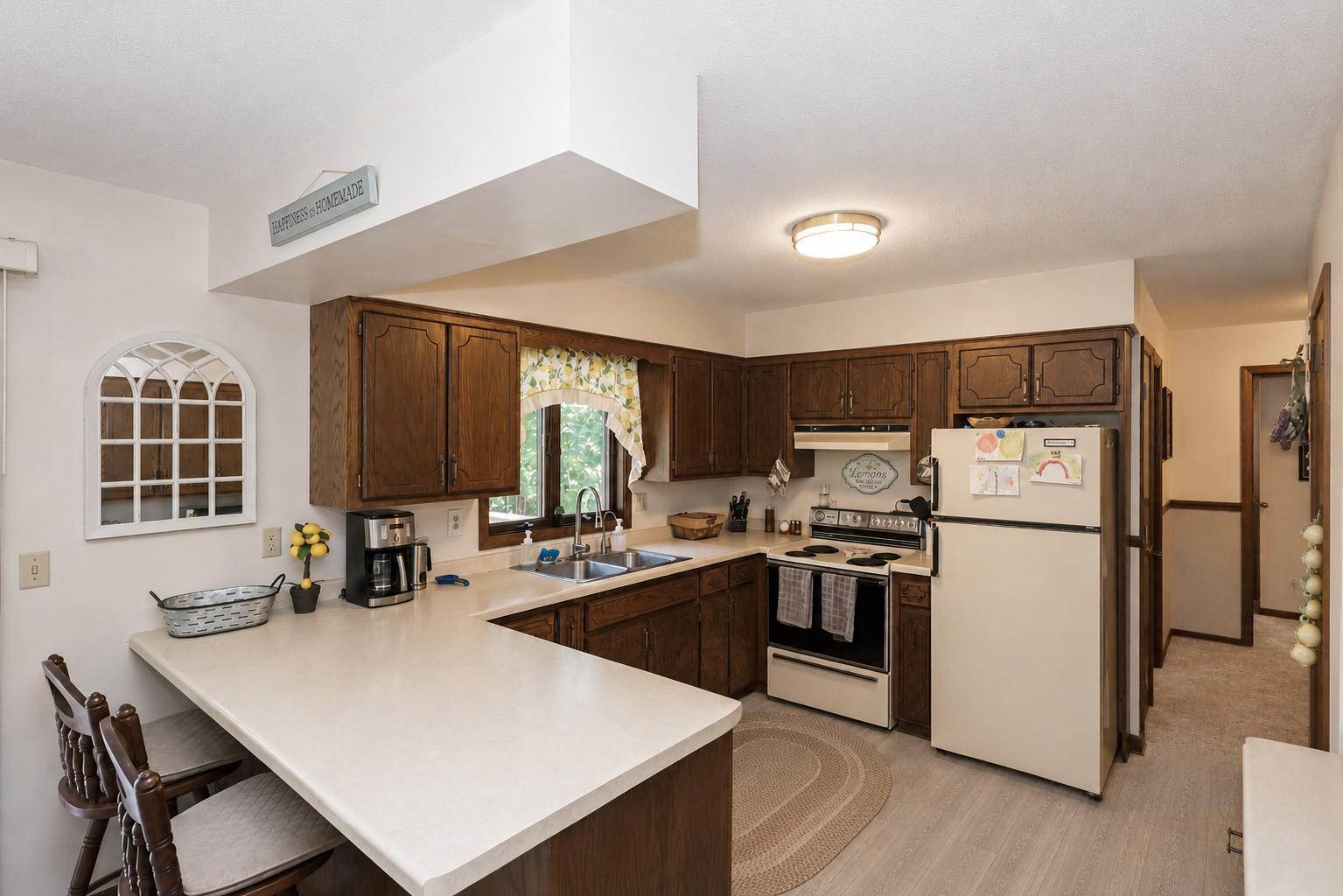 Kitchen area with a window overlooking the backyard (Seller is ready to install New LVP).jpg