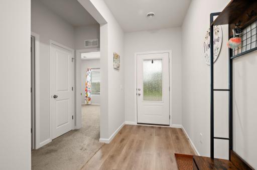 Step inside from the large front foyer to discover an airy open floor plan highlighted by knockdown ceilings and recessed LED lighting throughout