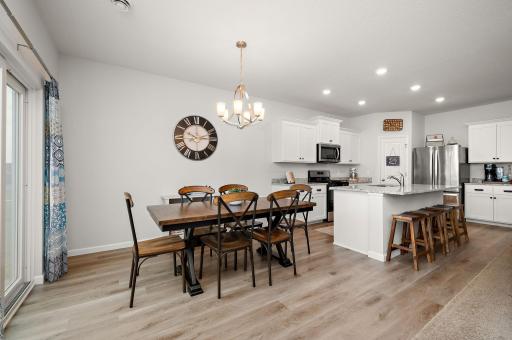 Dining room is open to kitchen, living room and access to stamped concrete patio