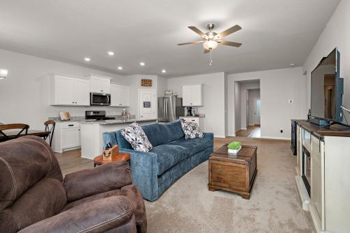 Living room is open to kitchen, dining room and access to stamped concrete patio