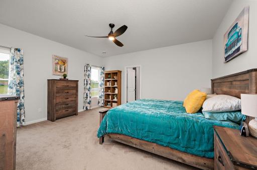 The expansive primary suite serves as a true private retreat, featuring a walk-in closet, double vanity sink, granite countertops, a large soaker tub, and a separate walk-in shower