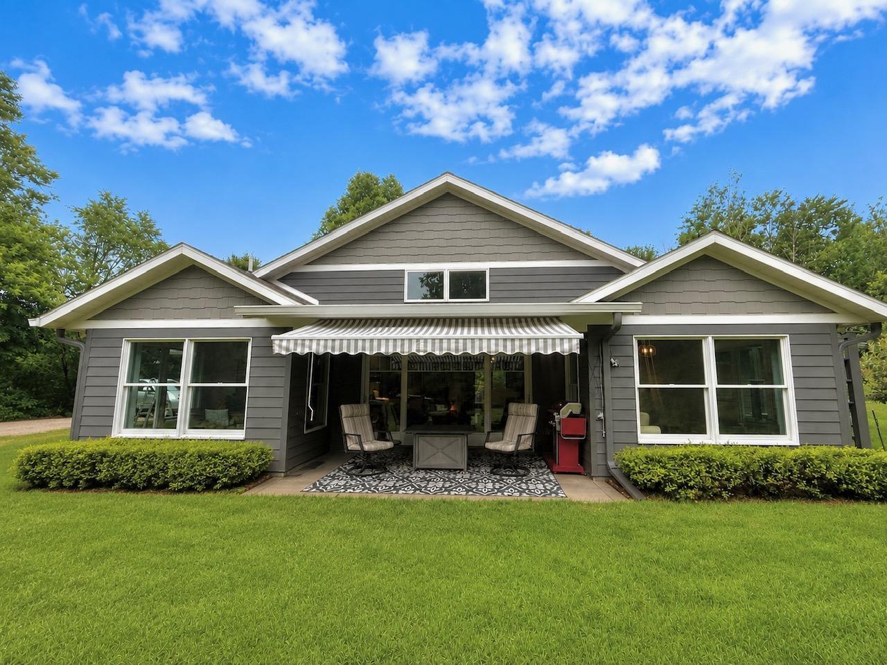Rear view with patio and retractable awning