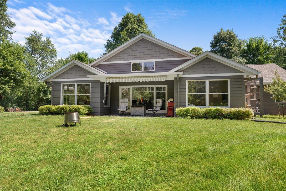 Rear view with patio and retractable awning