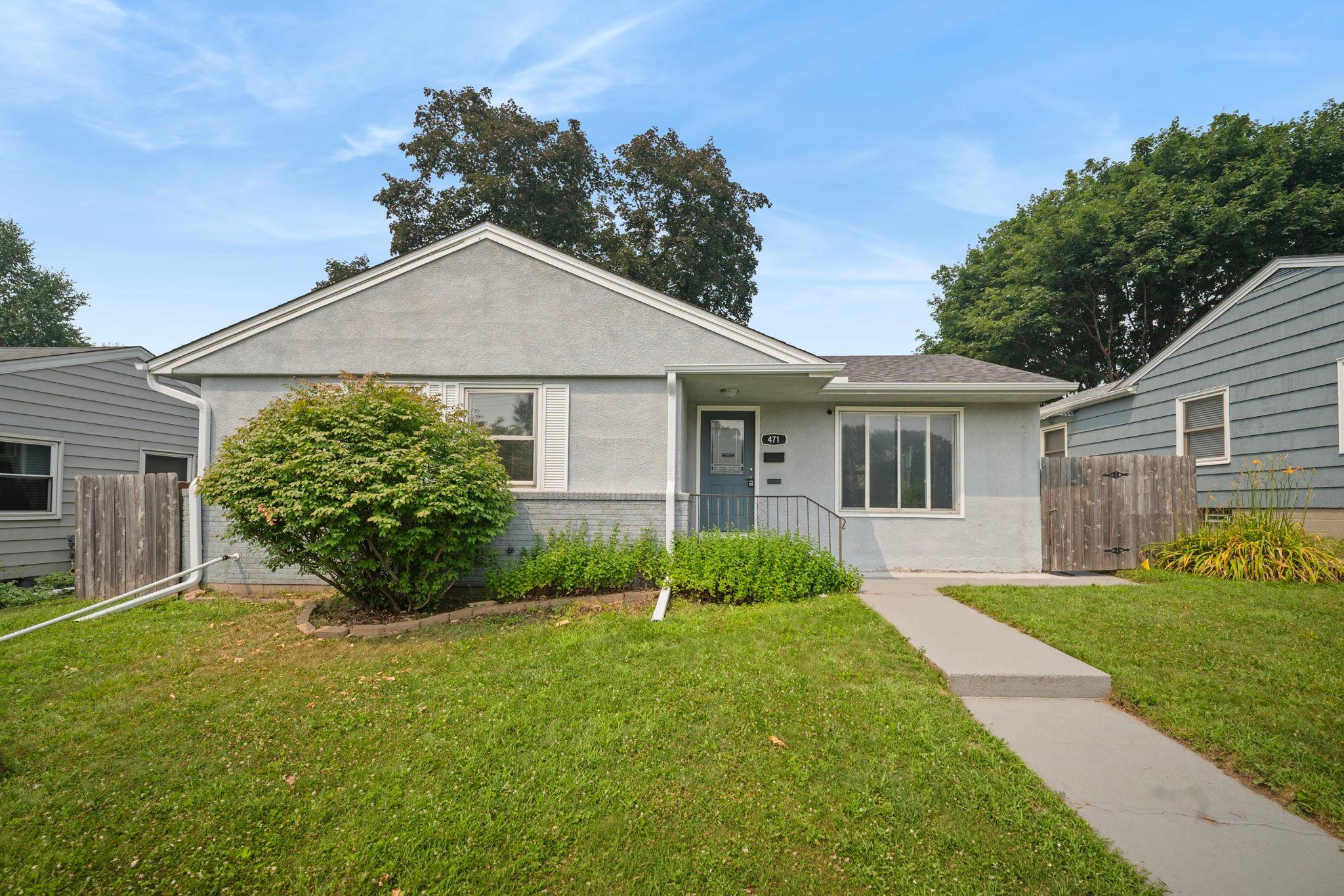 A single story stucco home framed by trees on a quiet Saint Paul street. Private, tucked in, and ready for its next chapter.