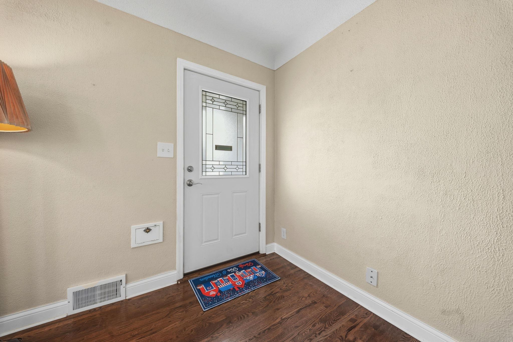 Step through the door and the day exhales. Warm light spills across rich wood floors, welcoming you home before you even set down your keys.
