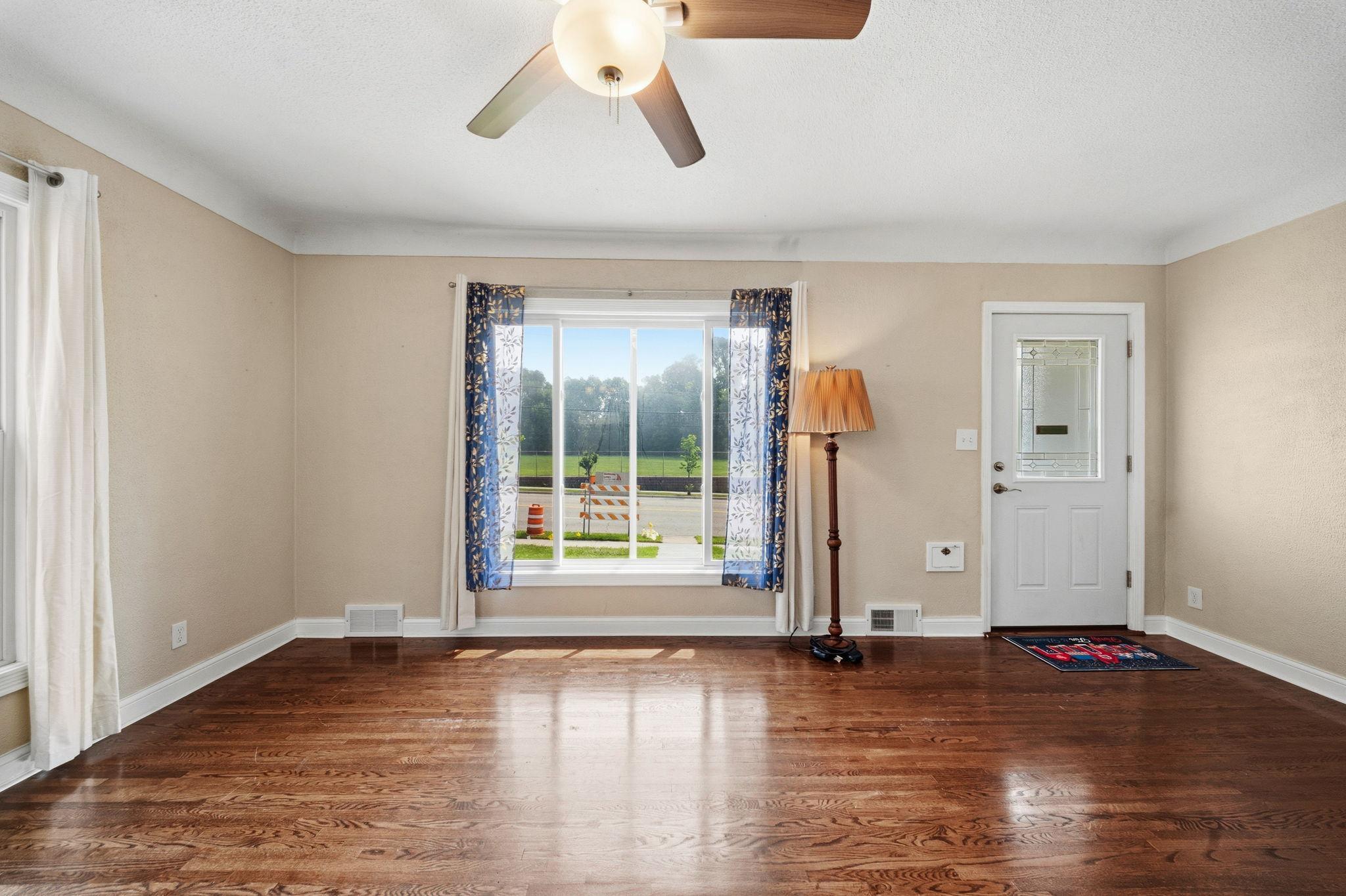 Light pours through the windows and pools on the original hardwood, floors that have carried decades of quiet mornings and Sunday afternoons. The whole family finds their own corner to land in. Evenings here slow all the way down.