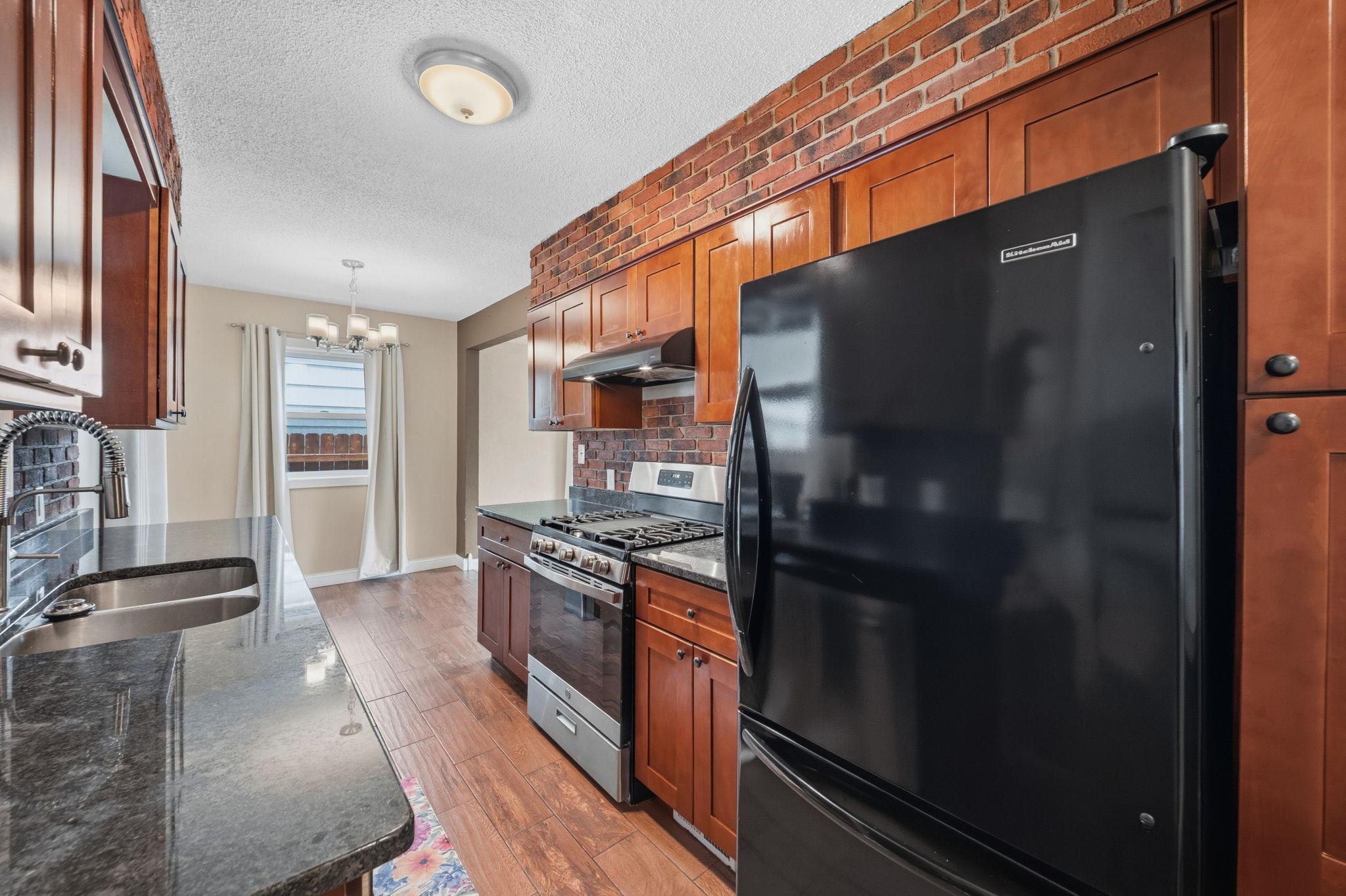 Three easy steps between stove, sink, and fridge, durable LVP floors ready for every spill. This is a kitchen built to keep up with real life.