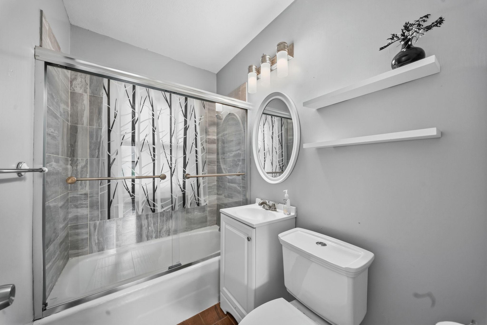 Soft grey tile and etched glass turn this bathroom into a quiet escape. Morning light, evening steam, the perfect reset twice a day.