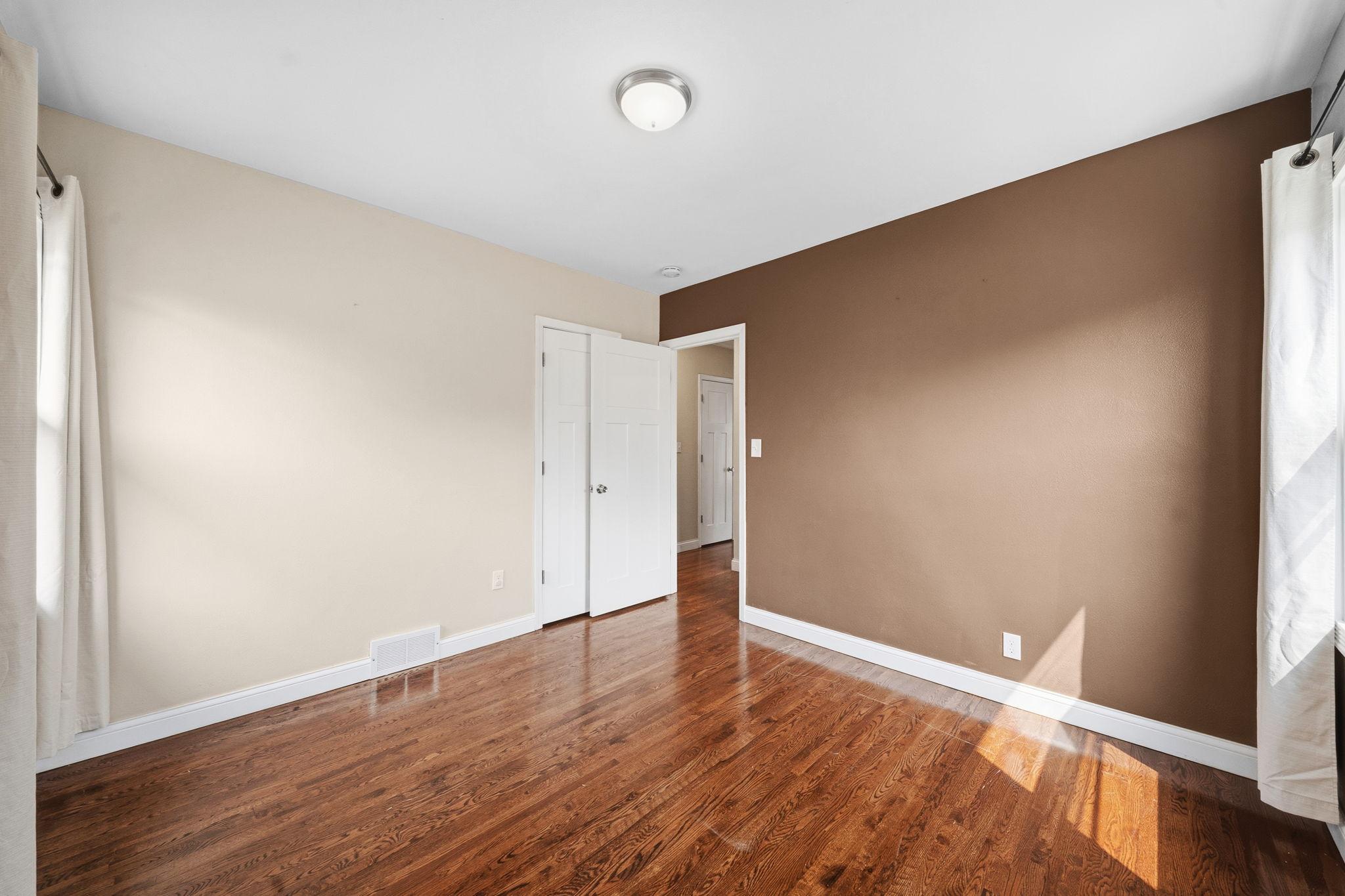 Just steps from the hallway, this quiet second bedroom on the main floor is a blank slate waiting for its next chapter. Simple, private, and ready to be made your own.