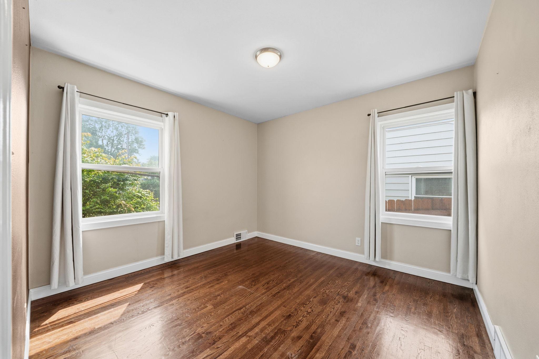 Sunlight pours across original hardwood that has never looked better, filling this main floor retreat with warmth. Room to breathe, room to unwind, right where you need it most.