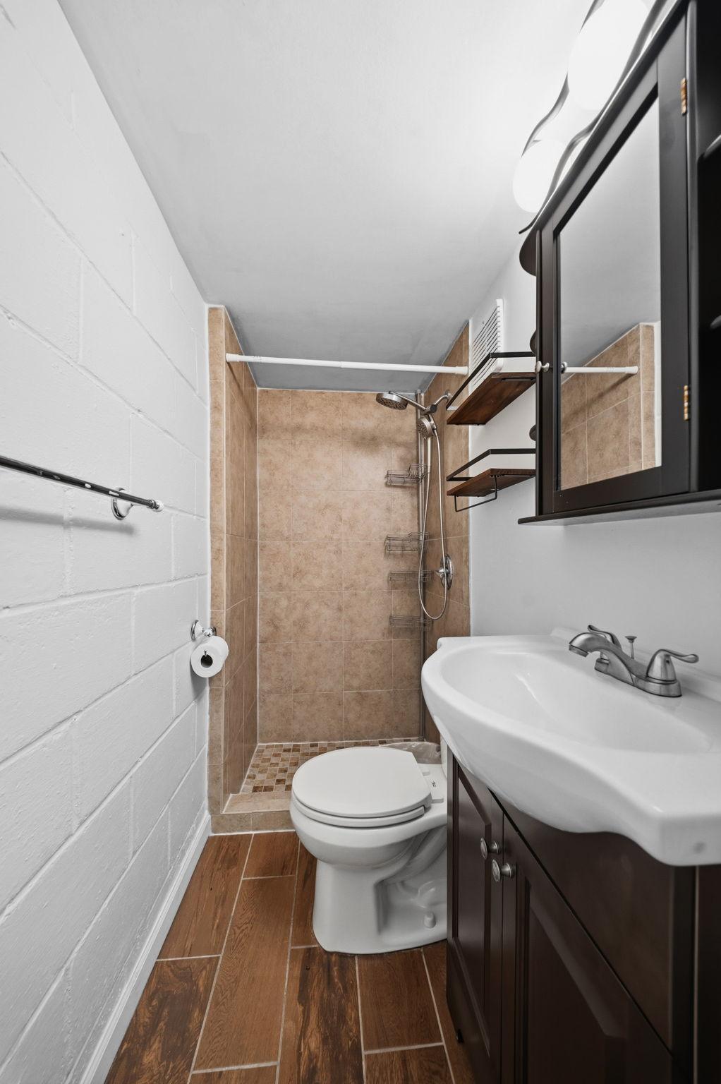 Step into the tiled walk in shower after a workout, no door or curtain in the way. Warm floors underfoot make this lower level 3/4 bath feel finished, not forgotten.