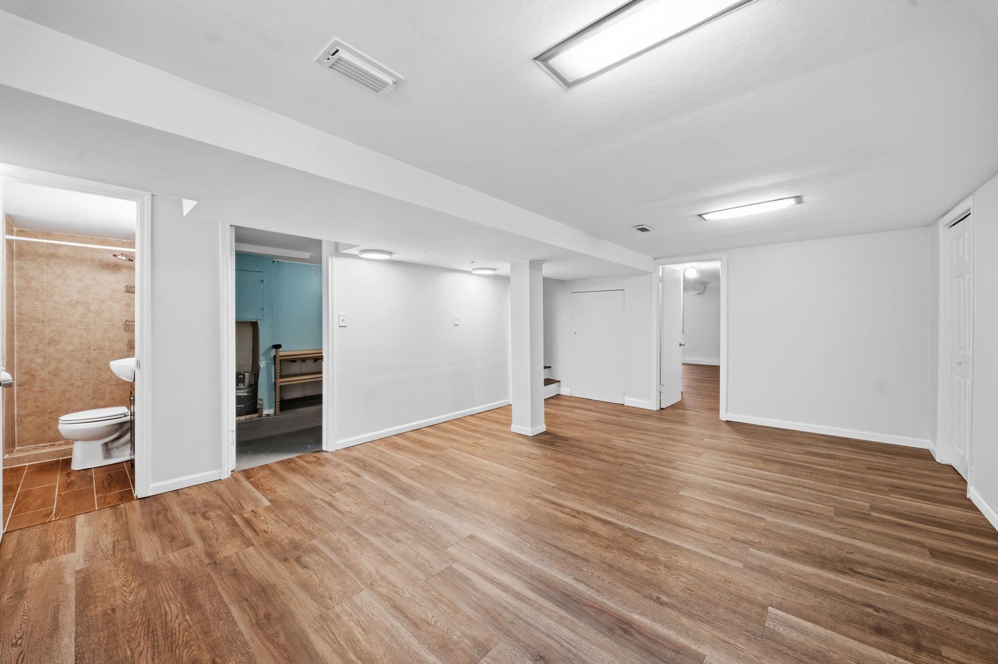 This lower level family room is wide open and waiting for movie nights, game days, and everything in between. Wherever your family needs more space to gather, it starts here."