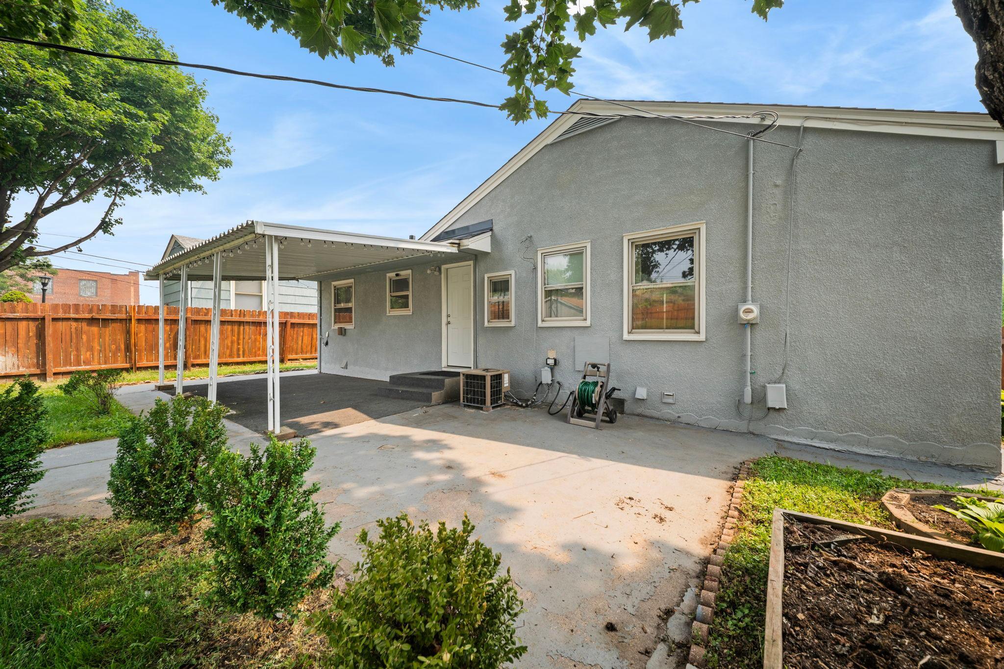 The back of the home opens to patio and yard on every side, with a privacy fence keeping it all your own.