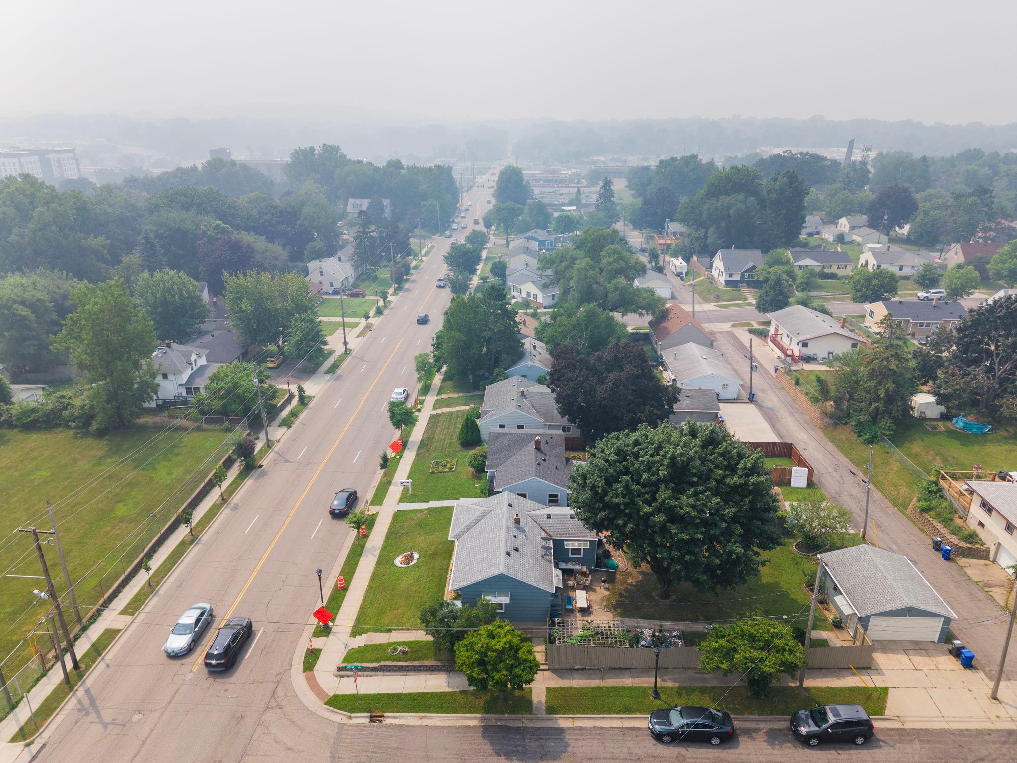 The street stretches out in both directions from above, framed by mature trees and easy access to main roads. Convenience and calm, side by side.