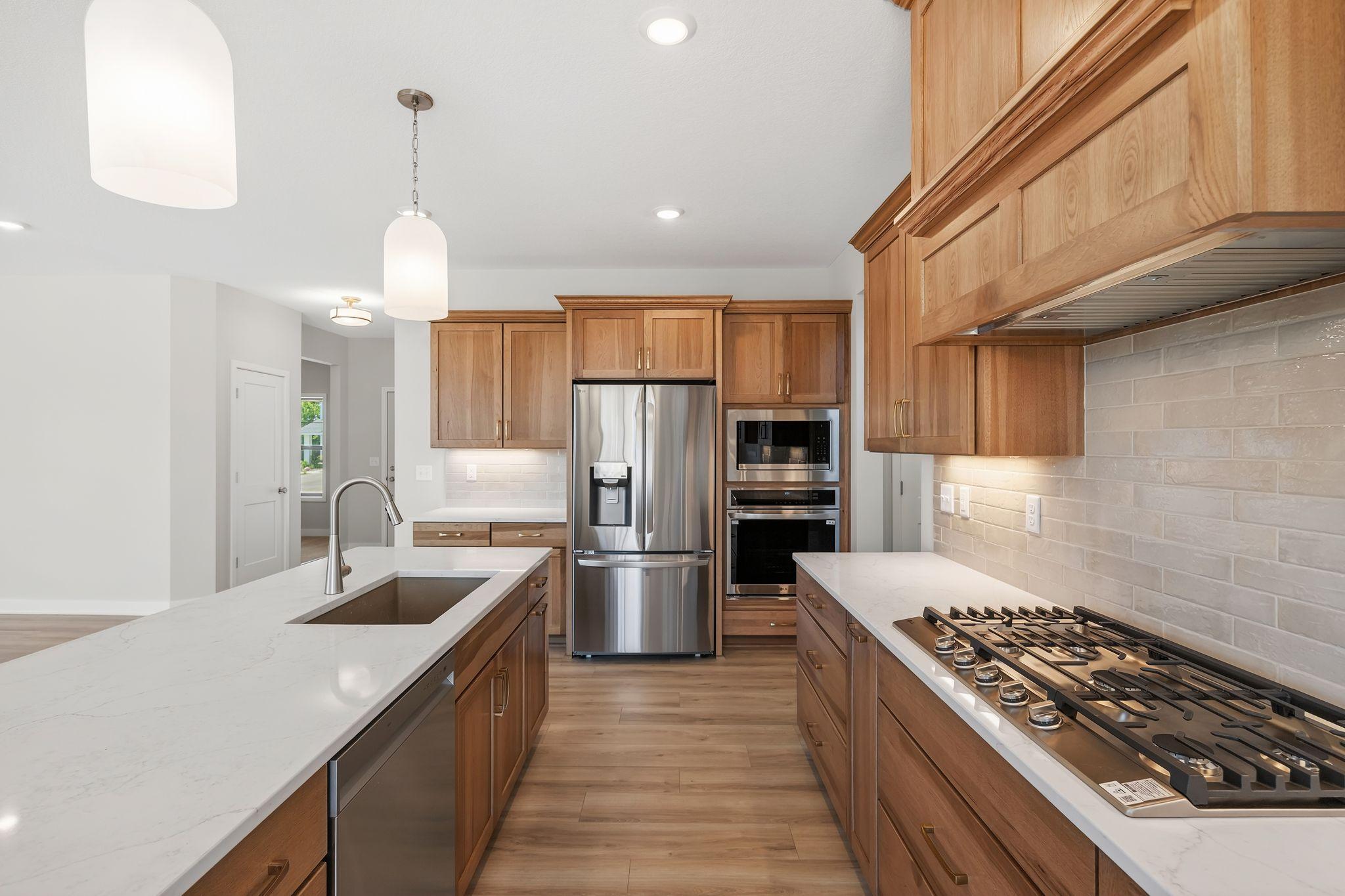 Gas cooktop with beautiful liquid tile backsplash.
