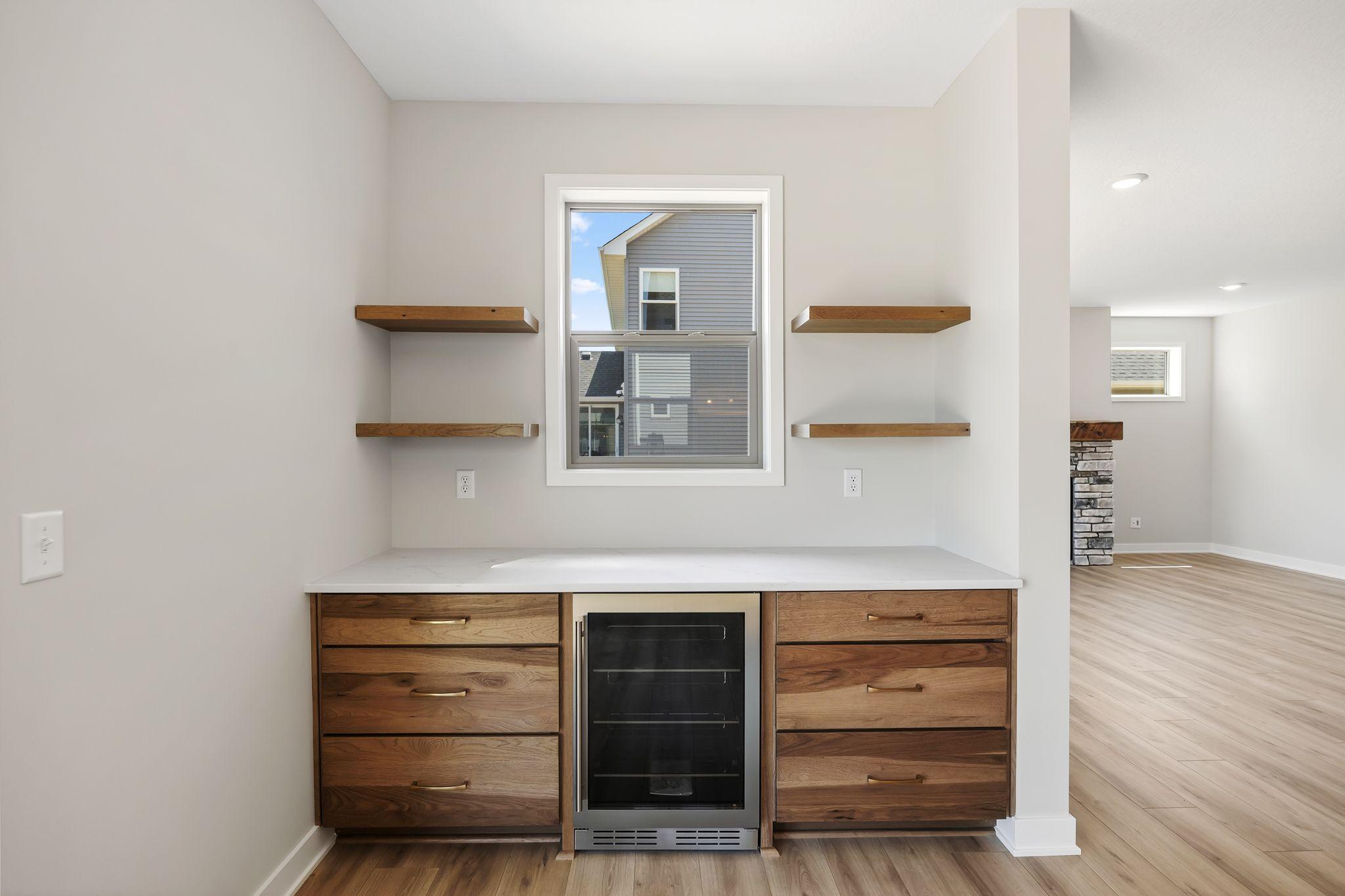 Built-in coffee bar with mini fridge, ready for company.