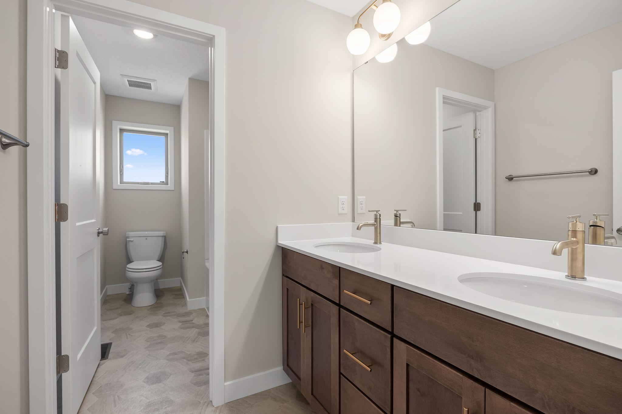 Full upper level bathroom with double sinks and....