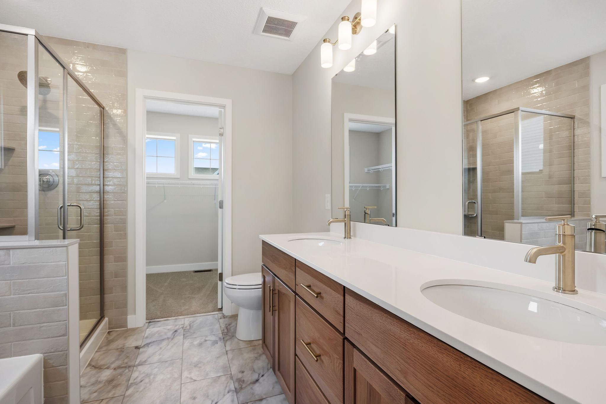 Owner's full bath with tile shower & bath surround.