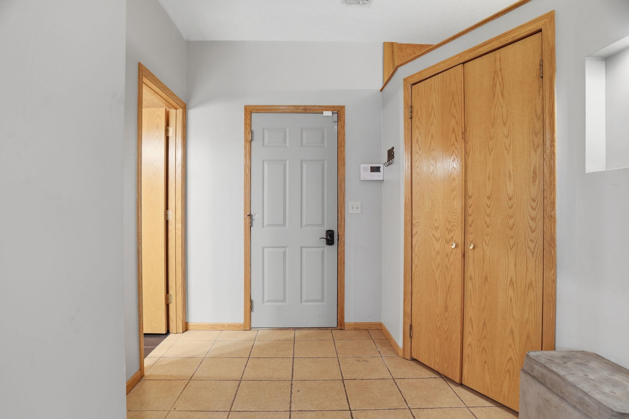 A practical mudroom entry off the garage keeps life organized, with a full closet for coats and gear and easy access to the rest of the main level.
