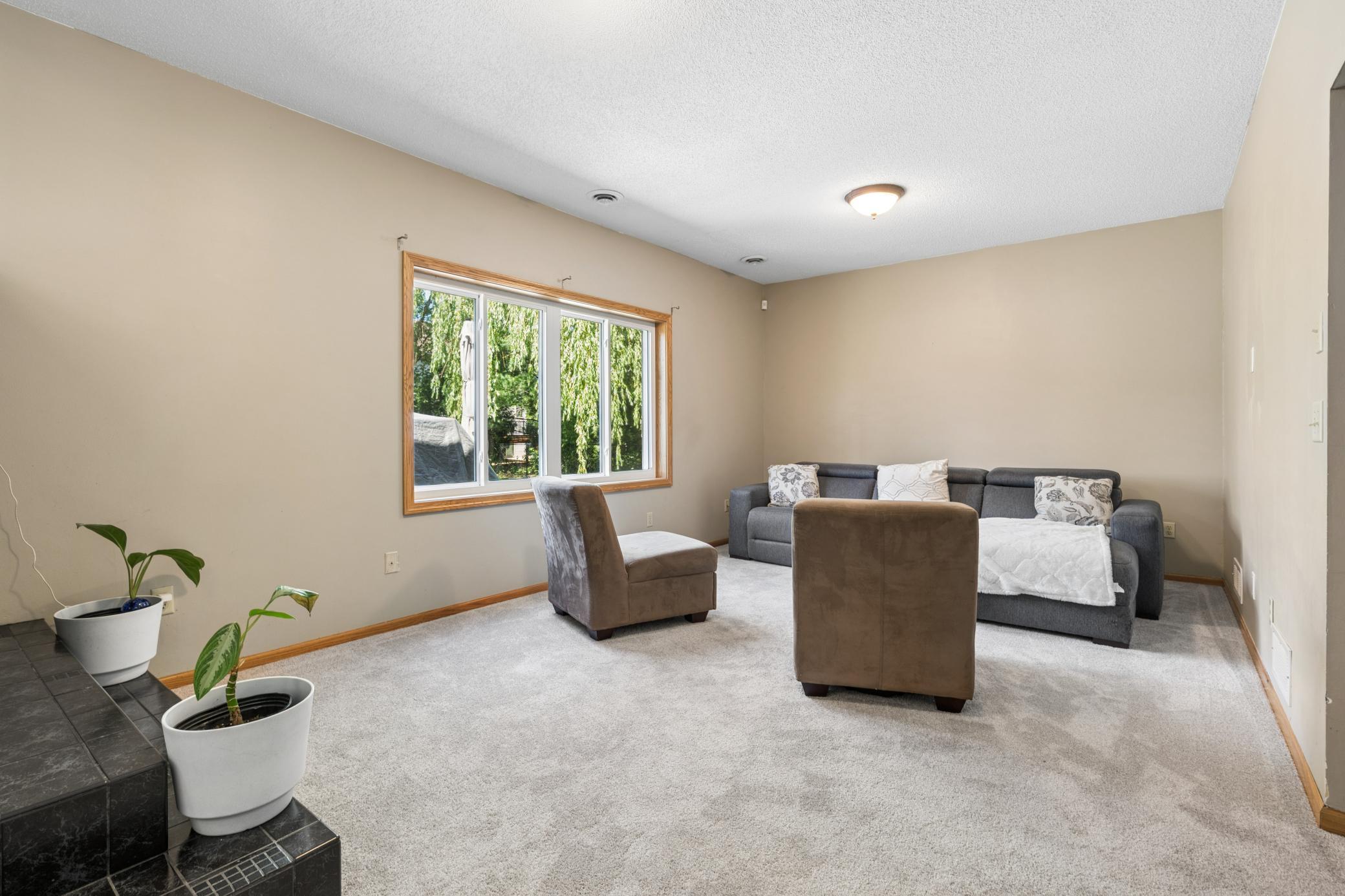 Guests stay. Kids spread out. Or you keep it for yourself. This lower level room adapts to whatever chapter you're in. French doors give it presence. The carpet gives it comfort.