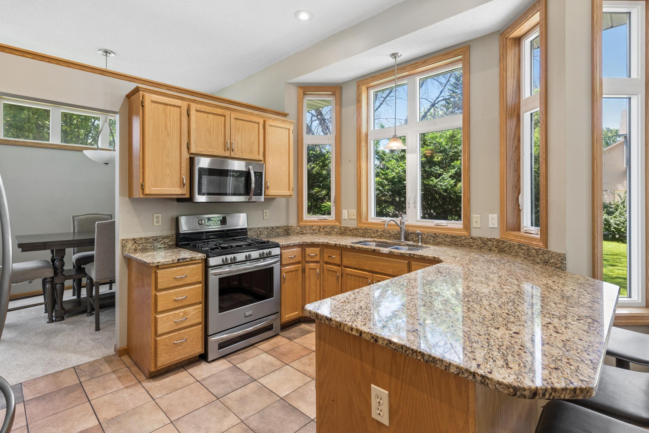 Bay windows that frame the yard like a painting while you cook, with the perfect Gas range and granite counters The kitchen works hard and looks good doing it. Stainless throughout. Storage everywhere.