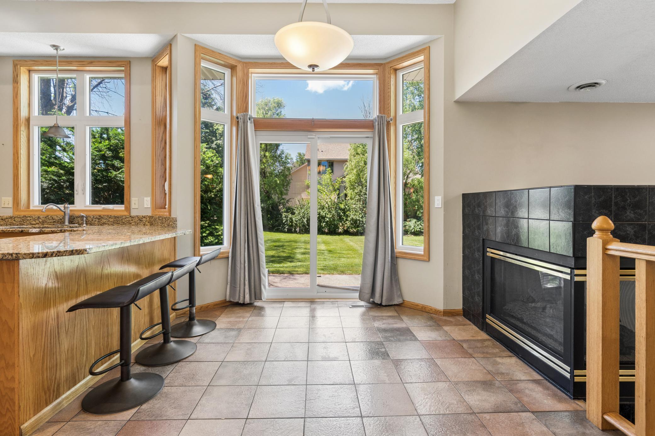 Where everyday moments feel a little brighter. The informal dining area is wrapped in oversized windows, features a breakfast bar for casual meals, and opens directly to the patio for seamless indoor-outdoor living.