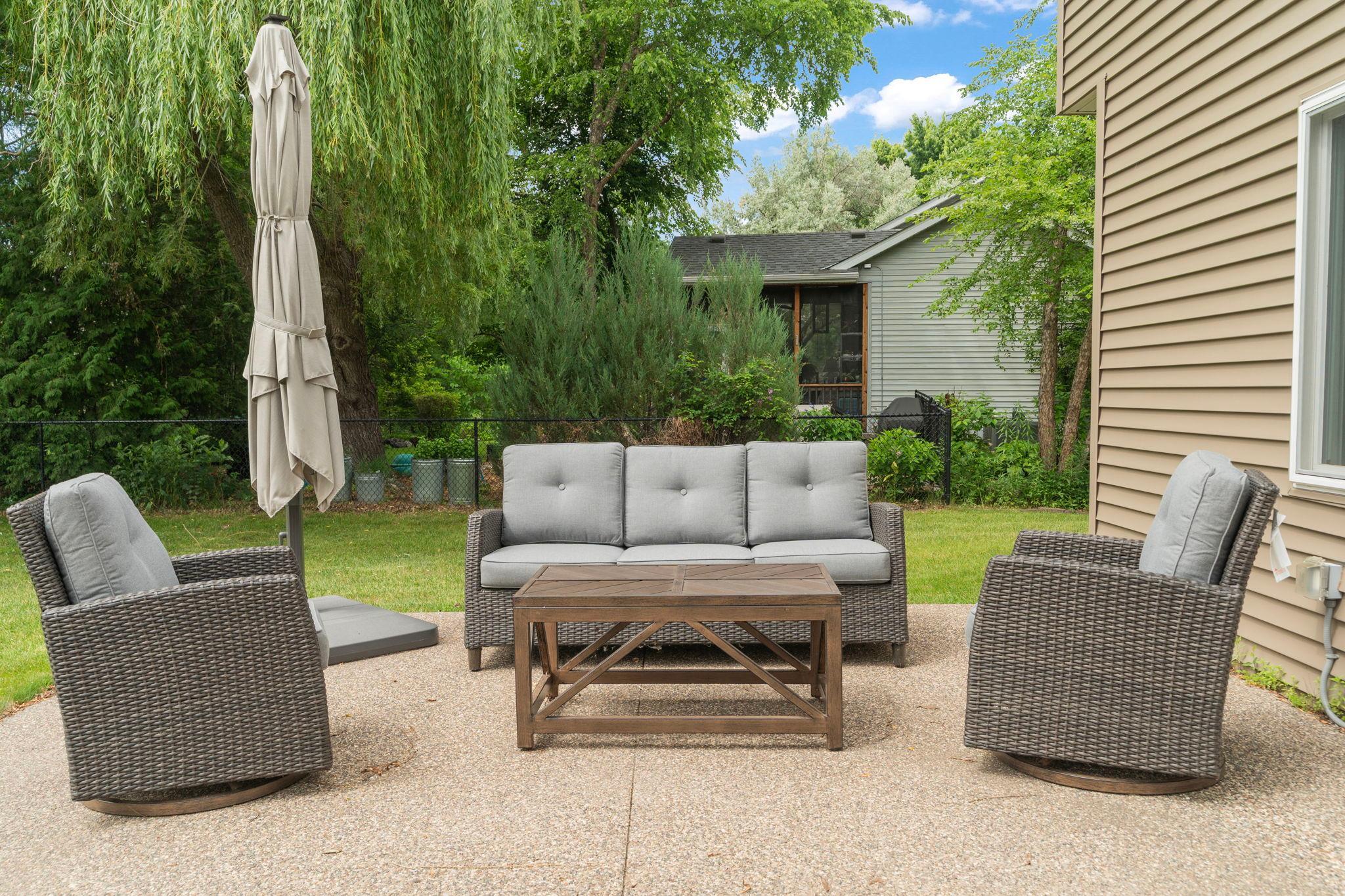 Patio space opens to a private, tree lined backyard, the willow swaying just beyond. A quiet corner for evening conversation, away from the everyday noise. Privacy that feels rare this close to town.
