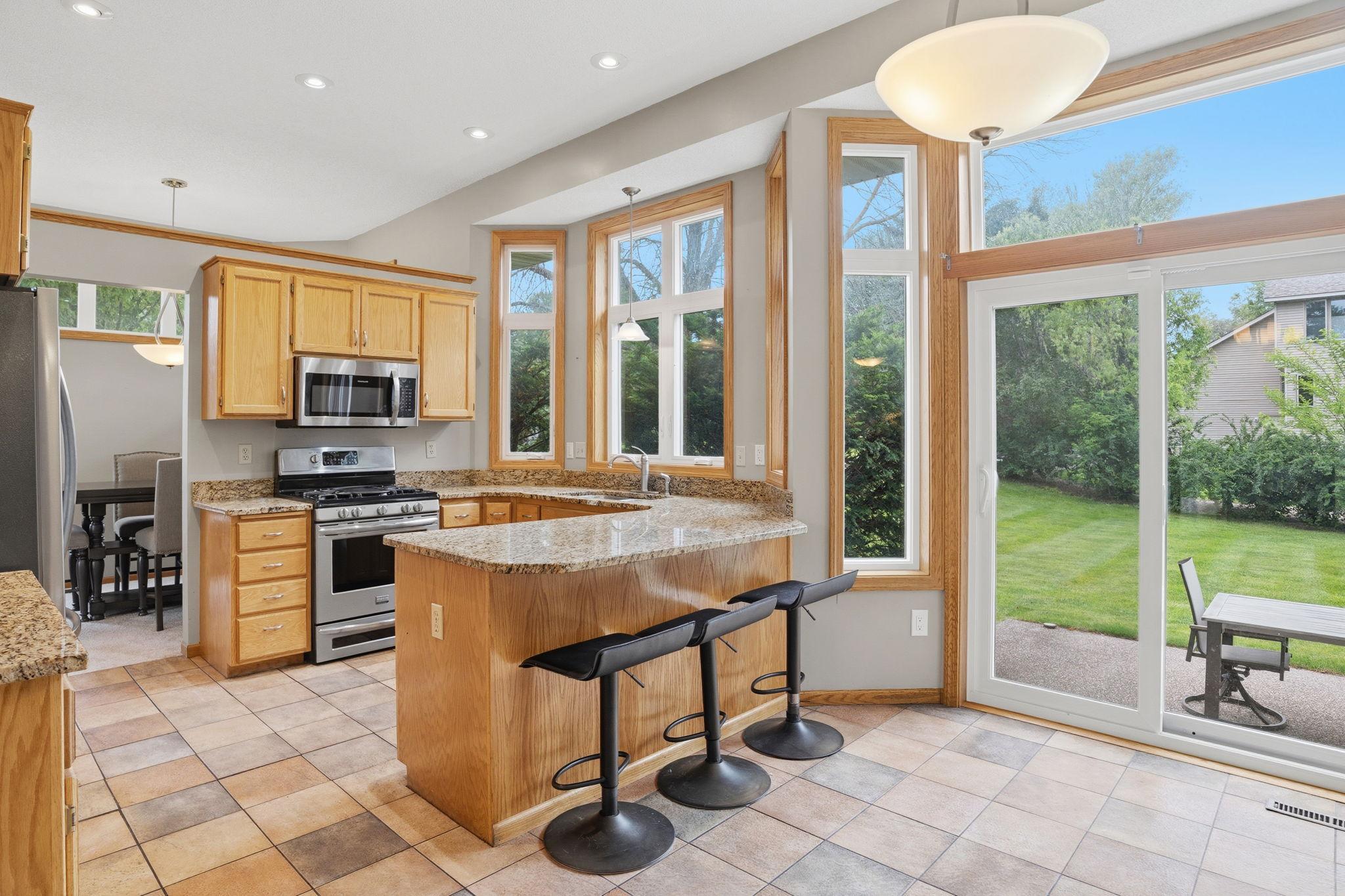 Morning coffee at the island. The sliding door open to the patio. The backyard going green. This is the kitchen that connects your whole life, inside and out.