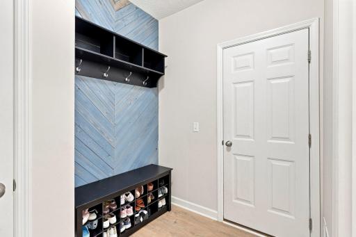 Enter from the garage into a well-designed drop zone featuring a spacious closet and dedicated space for shoes, bags, and everyday essentials.
