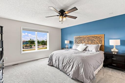Impressive primary bedroom provides a spacious walk-in closet and a large window showcasing beautiful natural light.