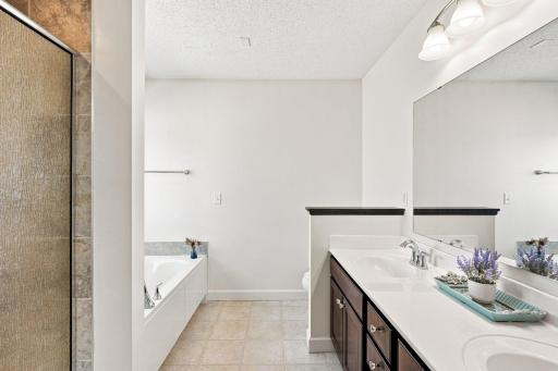 Primary suite is complete with a spacious ensuite featuring a soaking tub and separate shower.