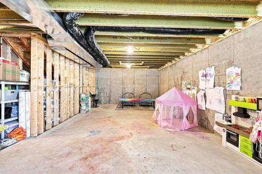 The unfinished basement provides a blank canvas ready for your vision.