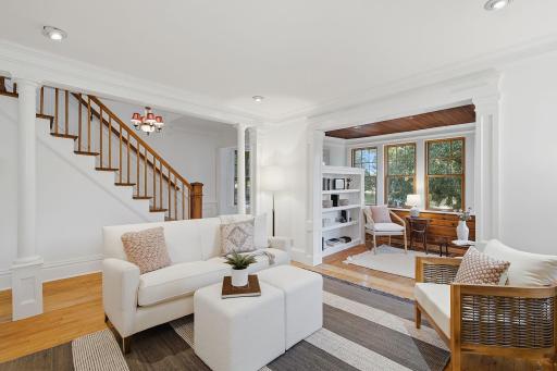 View towards the sunroom and entrance hall. Vintage columns punctuate the room.
