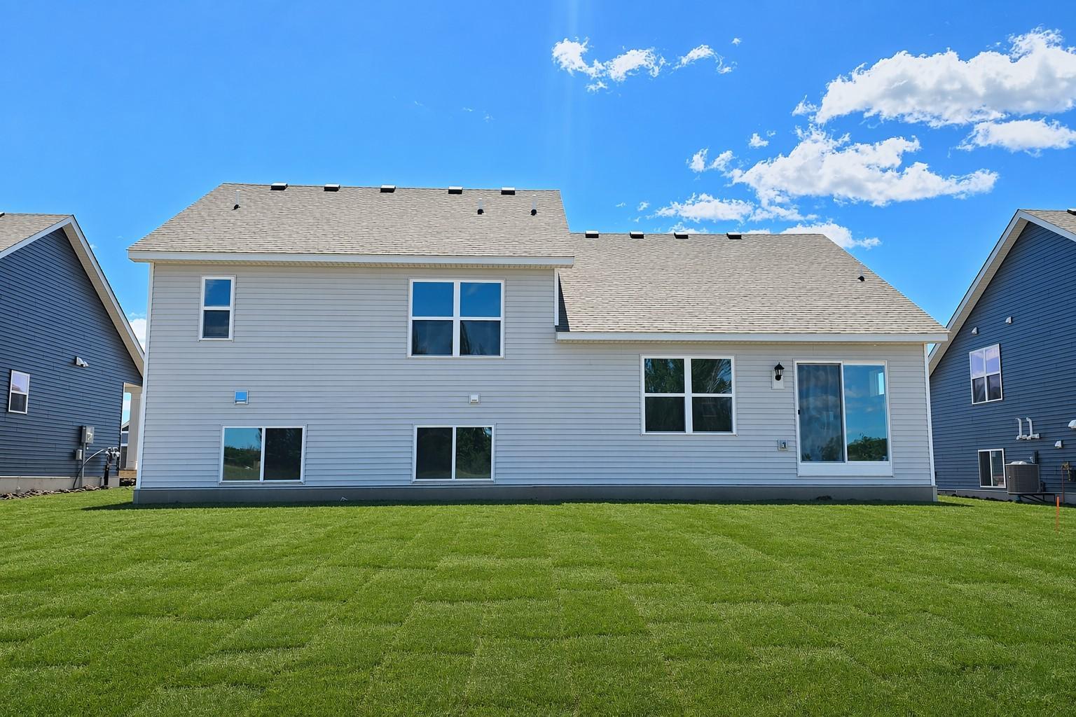 The Finnegan rear view of lookout at Highlands at Eagle View in Elko New Market. Photo is of actual home. Options and colors may vary. Ask Sales Agent for details. AI-generated landscaping for visualization. Actual yard condition may differ.