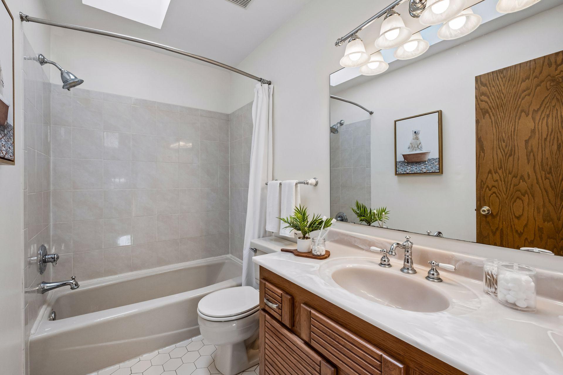Upper level full bathroom with tile flooring and shower.