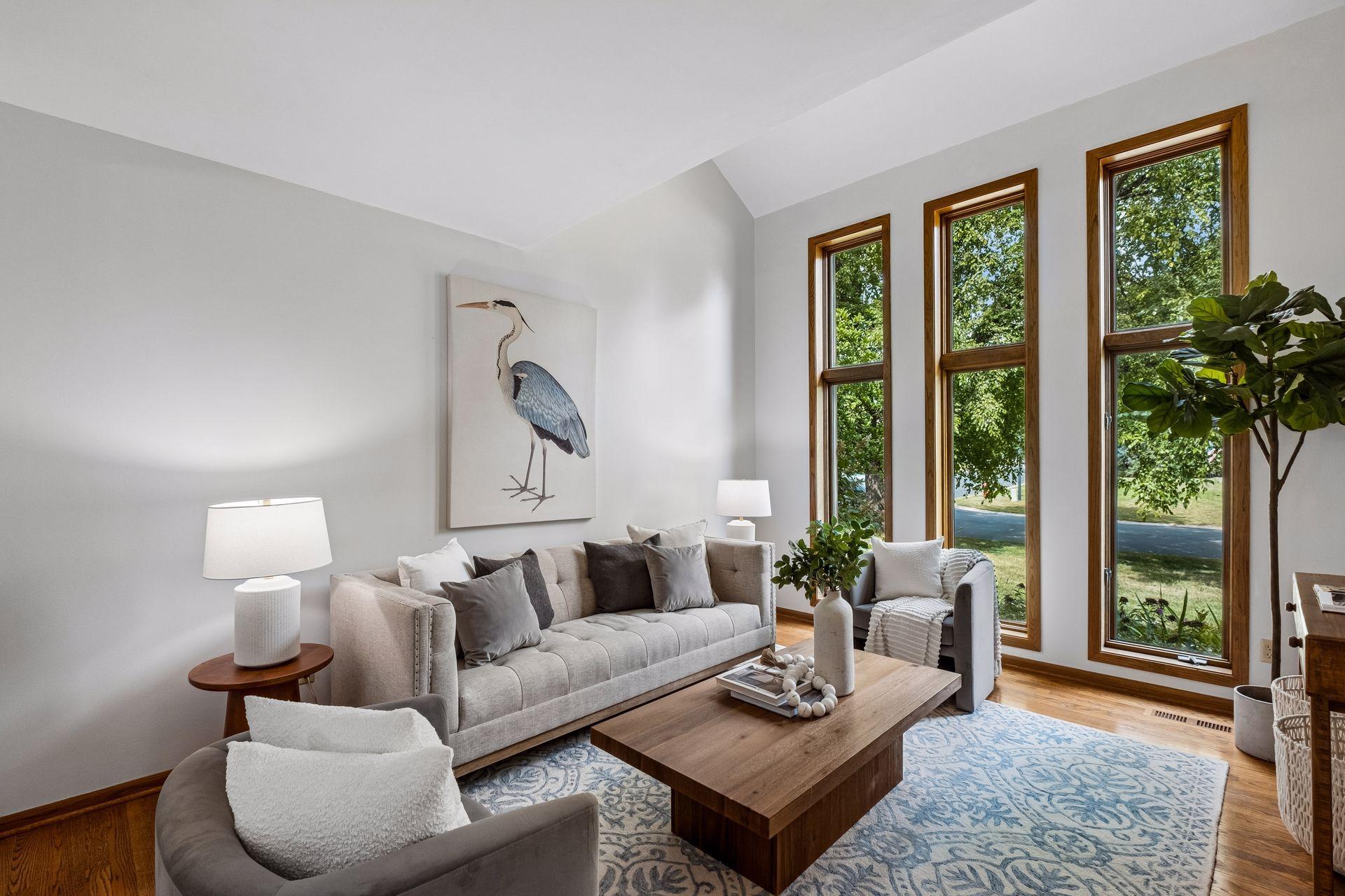Floor-to-ceiling windows bring in plenty of natural light, while beautiful hardwood flooring adds warmth to the space.