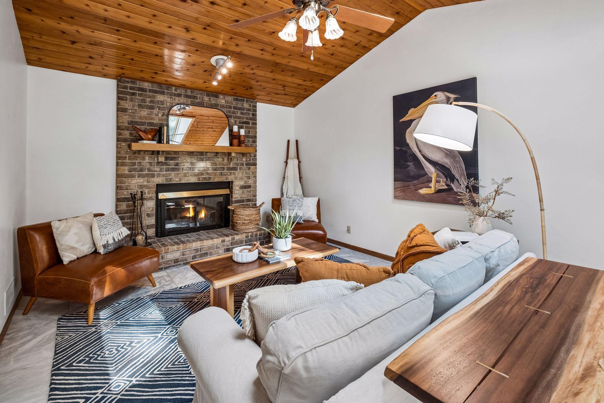 Stunning family room with a cozy wood-burning fireplace and vaulted cedar ceiling.