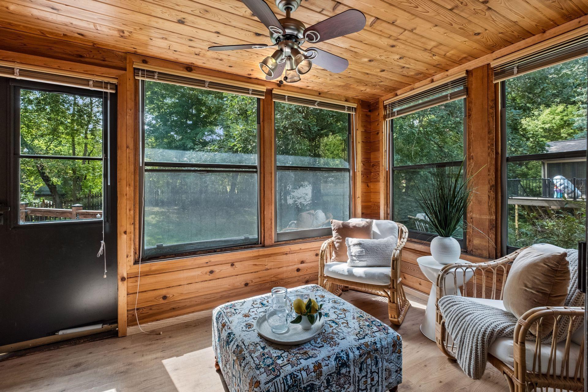 Beautiful three-season sunroom offers an inviting space to enjoy the beauty of the outdoors much of the year.