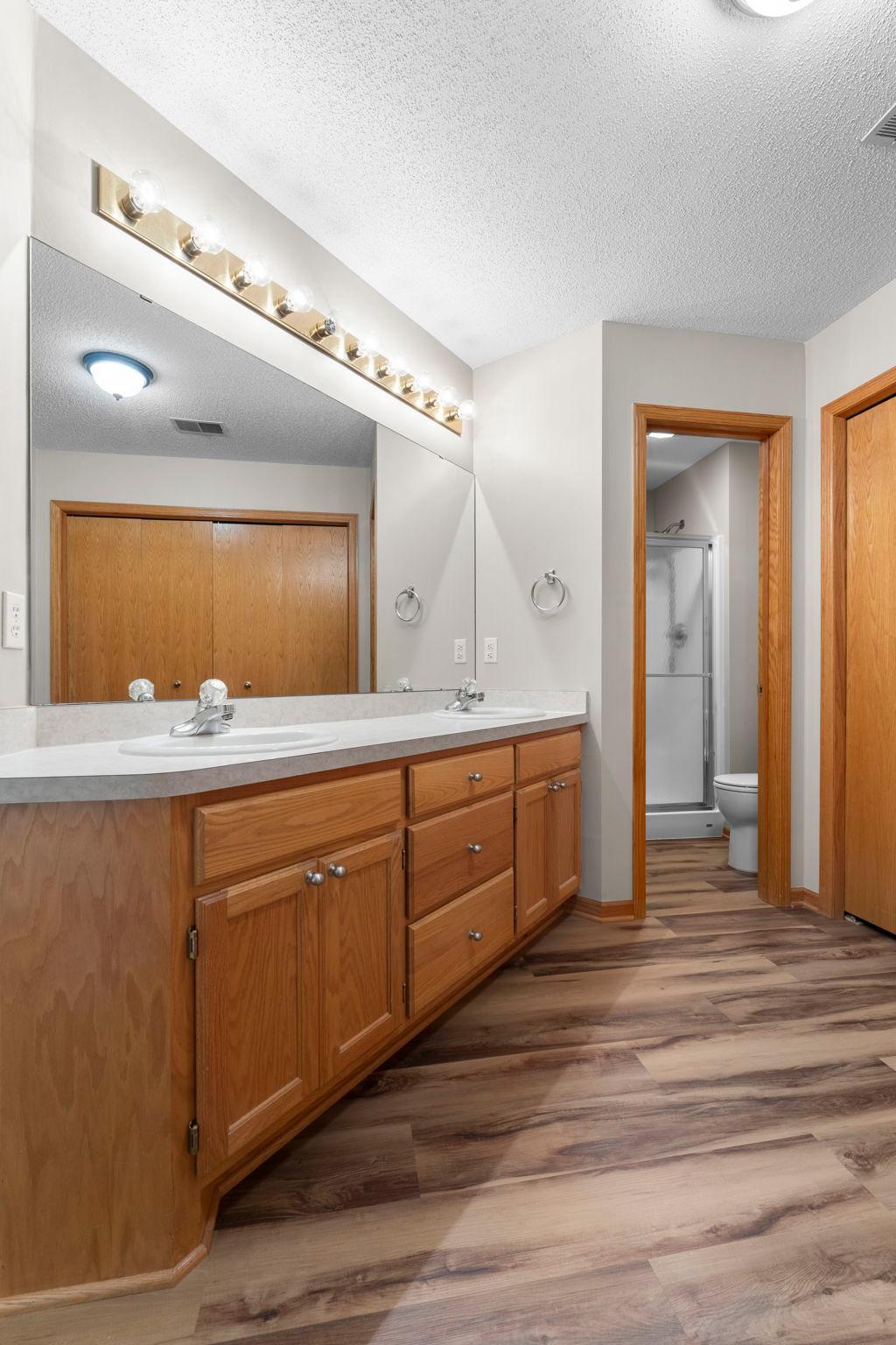 Dual vanities and separate stool and shower room.