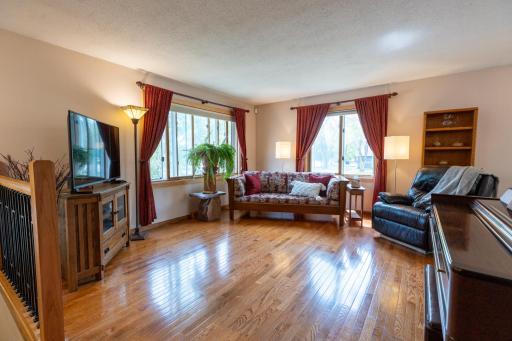 Bright, spacious living room featuring beautiful newer oak hardwood floors.