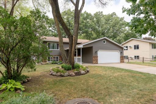 Welcoming split level with mature trees and new siding.