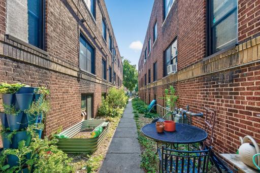 Side community space. Unit is located directly above the raised garden bed.