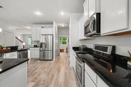 Another view of the Kitchen from the informal Dining Room area. The kitchen has access to the formal Dining Room with a passthrough area.