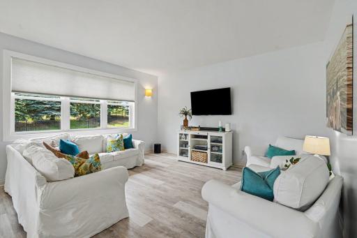 The family room has a triple window facing the backyard and is open to the kitchen and informal DR.