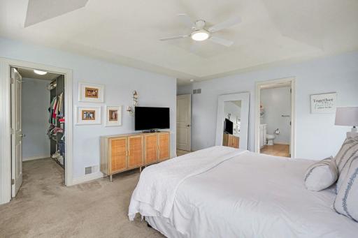 Another view of the primary bedroom shows the walk-in closet and access to the full primary bath