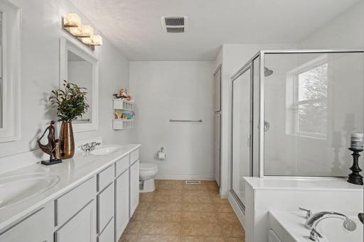 Primary bath has two sinks and a separate shower and tub.