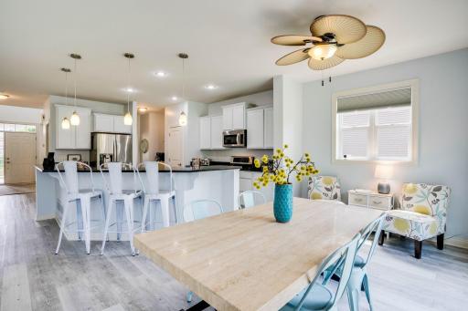 View from the informal dining room into the kitchen with seating at the large island