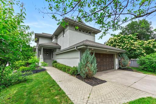 The stunning lakefront architecture is framed by mature landscaping.