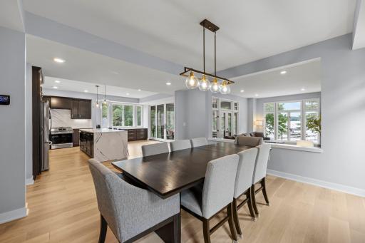 An inviting open-concept main level where the dining area, kitchen and lake-facing living spaces flow effortlessly together.